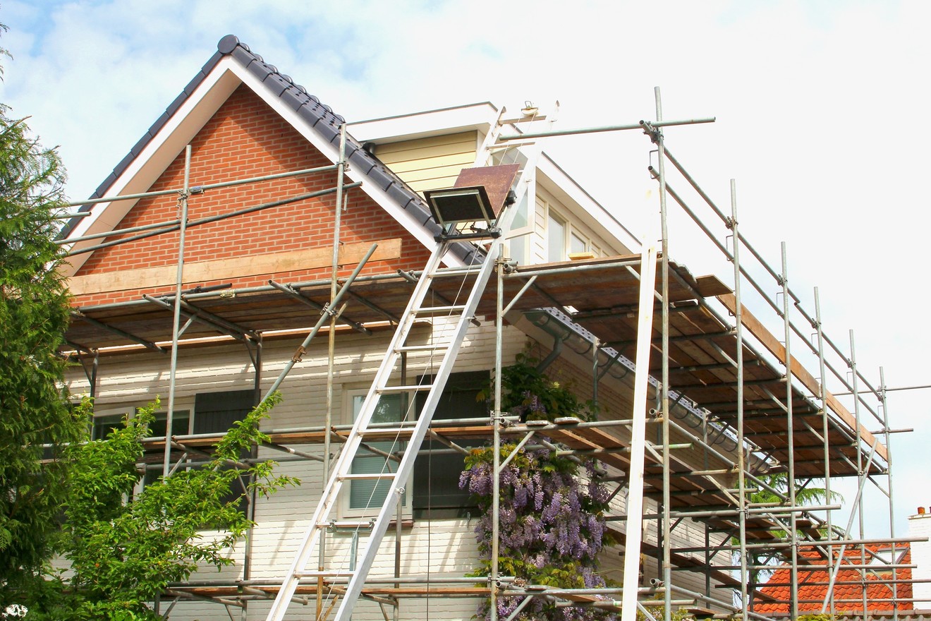 Exterior of a modern house and construction equipments