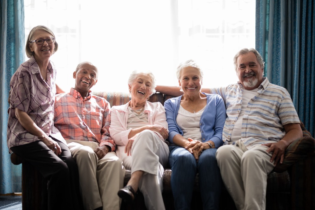 Smiling seniors on couch