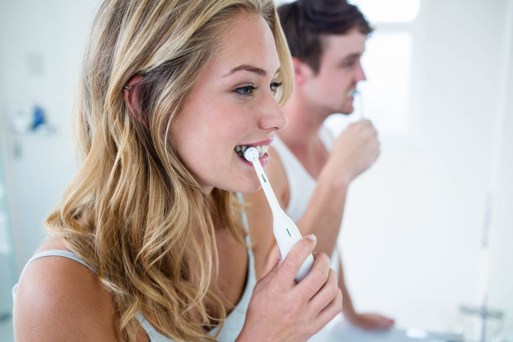 Couple brushing teeth
