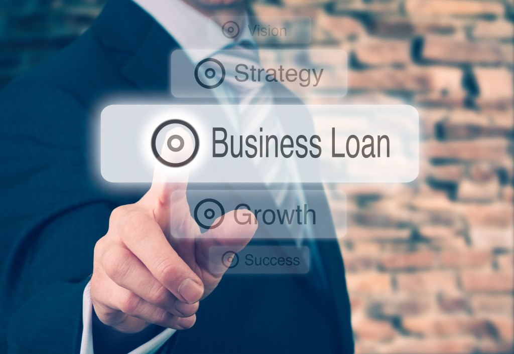 Businessman Pressing Business Loan Button