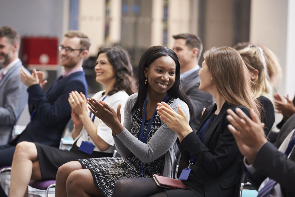 poeple clapping at a conference